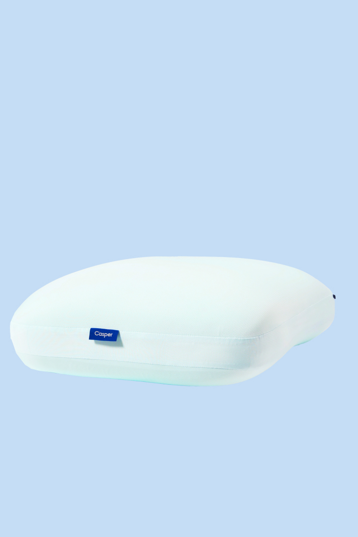 White pillows with a blue circle around them against a white background. The headline "Pillows" appears above the image.